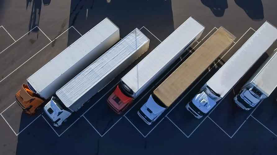 This image shows a bird's-eye view of trucks lined up in a parking lot.